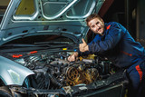 Mechanic working in car motor. Auto repair, Service center. Mechanic with wrench working and repair car engine in car service centre.