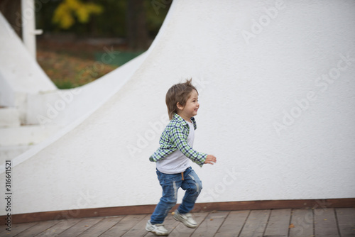 Happy boy runs around the stage. Blurred image