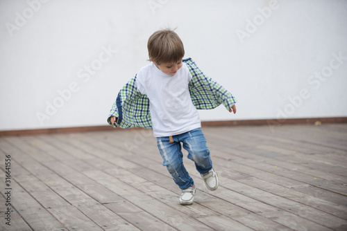 Happy boy runs around the stage. Blurred image