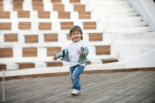 Happy boy runs around the stage. Blurred image