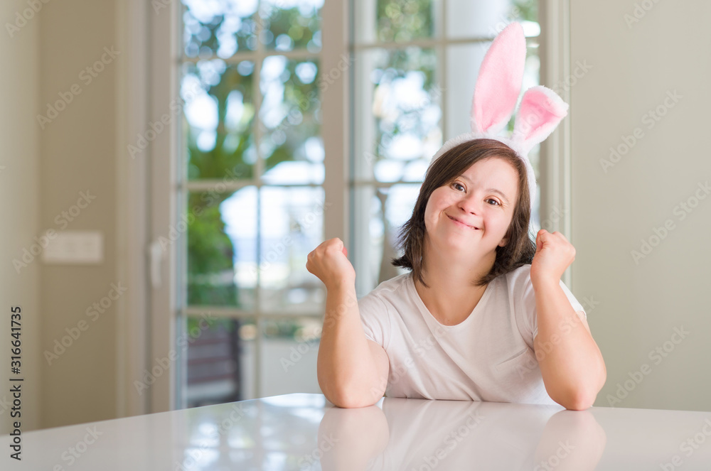 Down syndrome woman at home wearing easter rabbit ears screaming proud and celebrating victory and success very excited, cheering emotion Down syndrome woman at home wearing easter rabbit ears screaming proud and celebrating victory and success very excited, cheering emotion