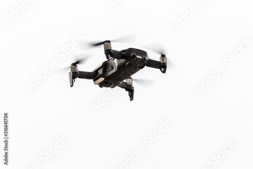 Fototapeta Naklejka Na Ścianę i Meble -  drone copter flying with digital camera.Drone with high resolution digital camera. Flying camera take a photo and video.The drone with professional camera takes pictures of park