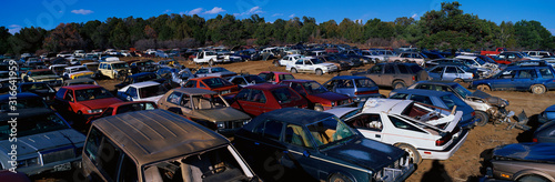 This is an auto salvage yard. The cars here are either crashed vehicles or no longer in use. They are wrecks all parked side by side.