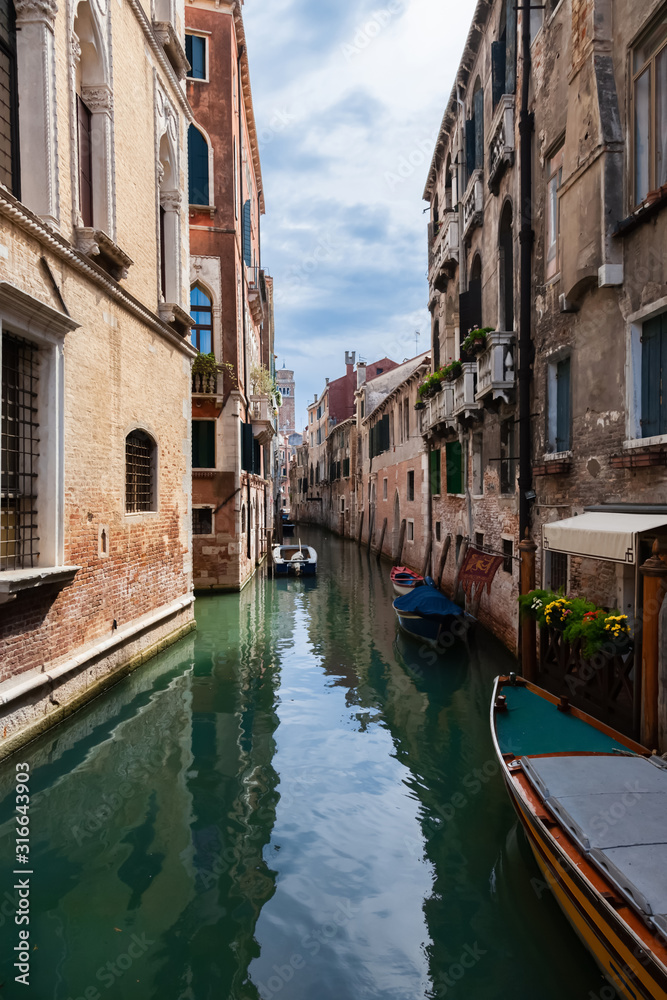 Typical Venice narrow canal with boats. Italy