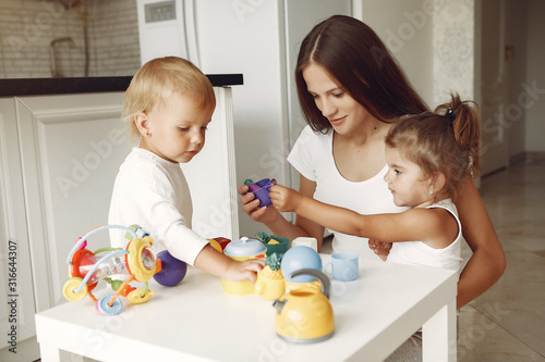 Mother with children. Kids playing with toys. Family in a bathroom