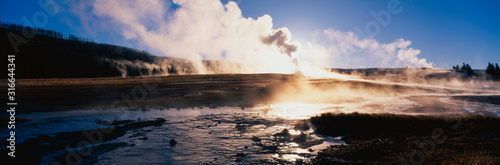 This is the famous Old Faithful Geyser. The geyser is erupting at sunrise.