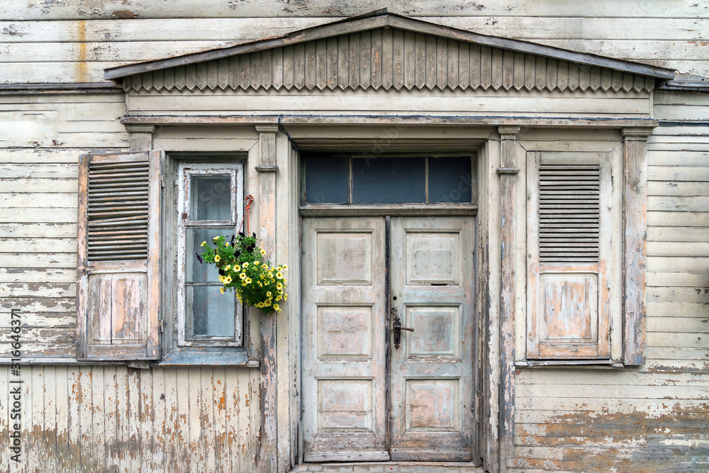 Facade of old white wooden home Facade of old white wooden home