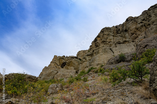 Mountain landscape. Sheer cliff and sky. Travel and adventure.