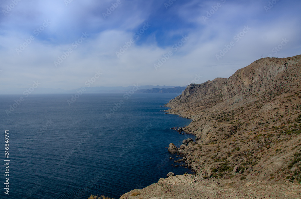 Sea and mountains. Seascape rocky coast. Sunny day. Sea and mountains. Seascape rocky coast. Sunny day.
