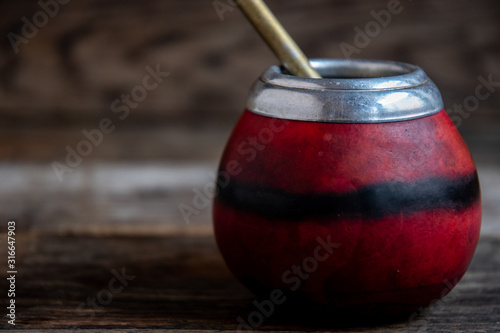 Argentina Calebas (Bowl) for Mate, straw, gourd pumpkin, original on a wooden table. photo