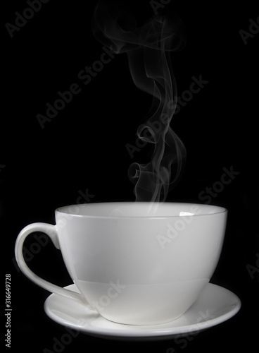 White porcelain cup on black background with steam