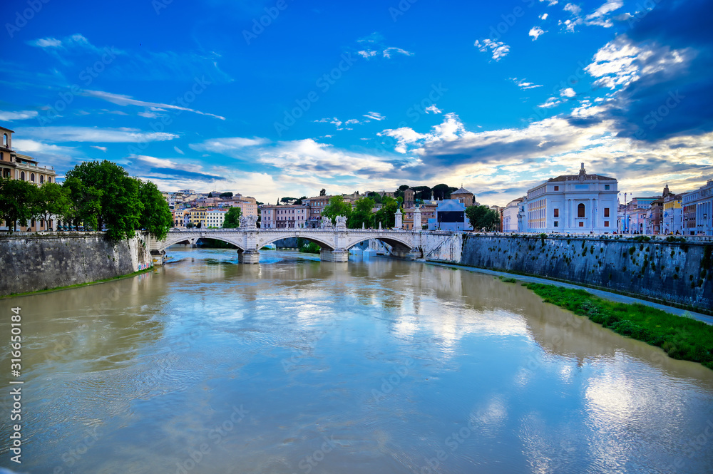 A view along the Tiber River towards St. Peter's Basilica and the Vatican in Rome, Italy.