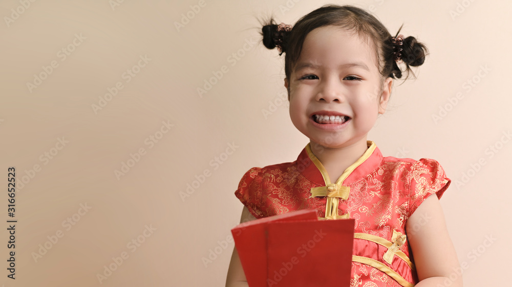 Little smiling curly Asian Girl hold red envelopes and smile to you. Chinese New year concept. Little smiling curly Asian Girl hold red envelopes and smile to you. Chinese New year concept.