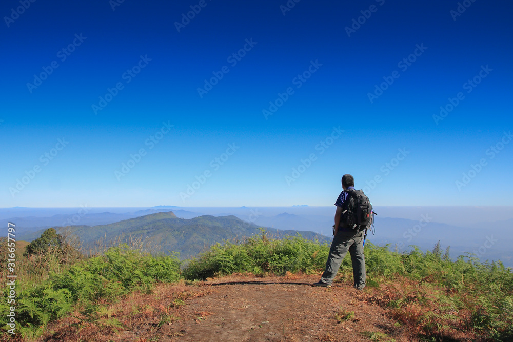 Man hiking Traveler with big backpack mountaineering Travel Lifestyle