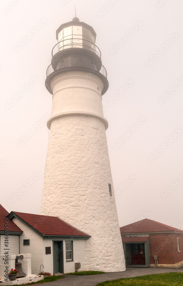 Close up of the Portland Head Lighthouse in dense fog.