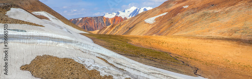 Mountain landscape  panoramic view. Snow-capped peaks  colored rocks.