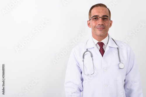 Portrait of mature handsome Persian man doctor © Ranta Images