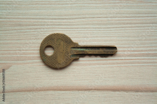 Close up macro shot of old rusty grunge key top view. Single key. Access, security, enter