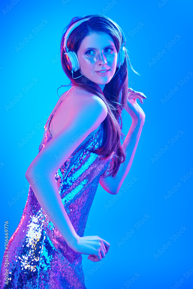 dancing in a shiny dress with headphones dancing in a shiny dress with headphones