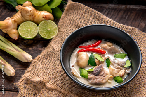 Chicken Coconut Soup (Tom Kha Gai),Coconut milk soup with chicken and Thai ingredients on the table, top view, Thai food that is popular in Thailand.