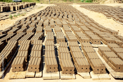 The production of ancient bricks in Thailand (the process of bringing bricks to dry in the sun)