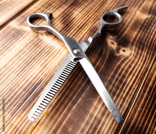 Scissors for haircuts on a wooden background