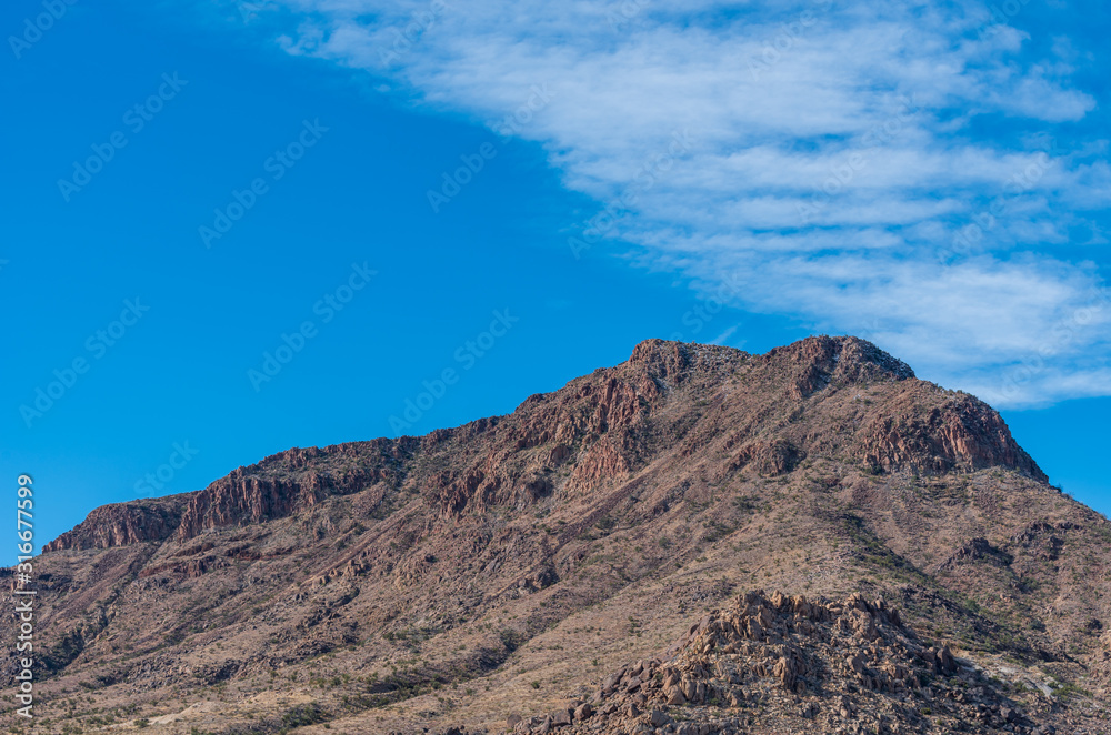 Low angle landscape of colorful barren stone mountain near Kingman, Arizona
