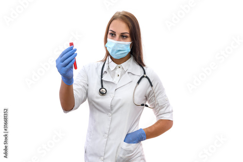 Attractive woman in medical uniform and protective mask holding red test tube isolated on white