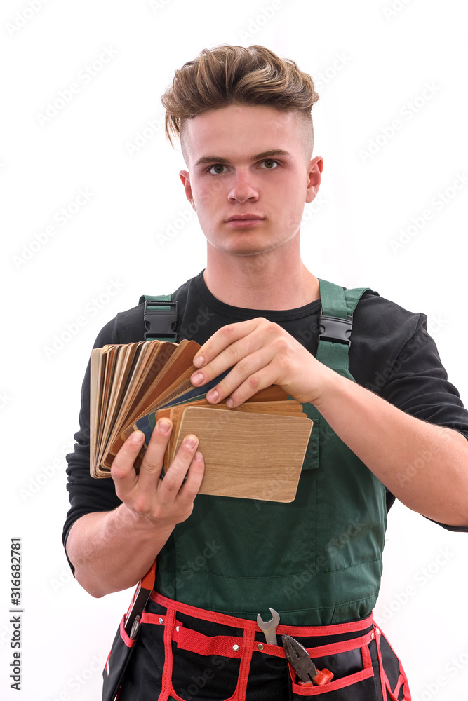 Man in coverall showing wooden sampler isolated on white Man in coverall showing wooden sampler isolated on white