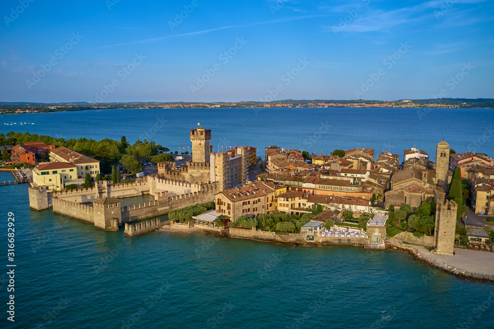 Unique view. Aerial photography, the city of Sirmione on Lake Garda north of Italy. In the background is the Alps. Resort place. Aerial view.