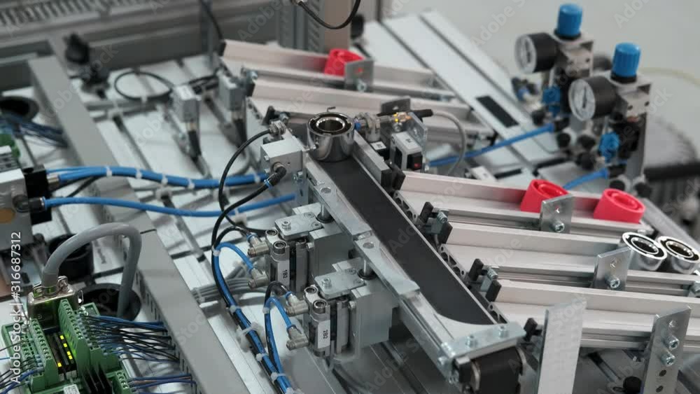 Close-up of product which automatically classified according to color in storage station. Handling and Sorting Application. Industry 4.0 concept; artificial intelligence in autonomous production. Close-up of product which automatically classified according to color in storage station. Handling and Sorting Application. Industry 4.0 concept; artificial intelligence in autonomous production.