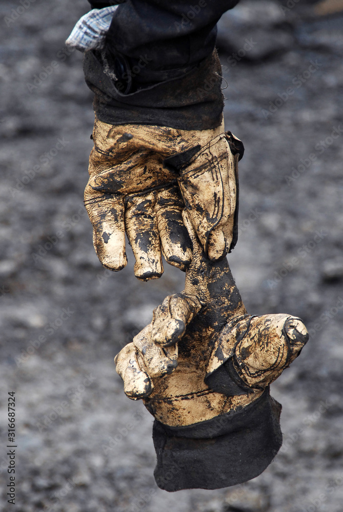 Used and damaged work gloves. Interesting texture of old safety gloves. Used and damaged work gloves. Interesting texture of old safety gloves.