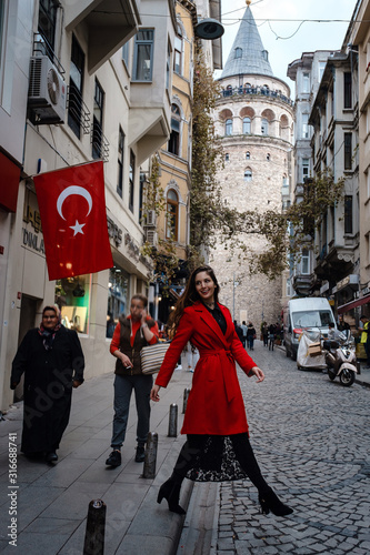 Portrait of beautiful woman with view of Galata tower in Istanbul, Turkey