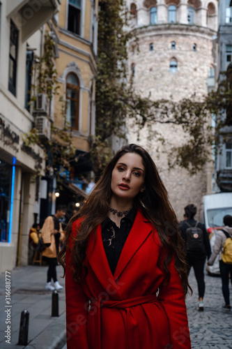 Portrait of beautiful woman with view of Galata tower in Istanbul, Turkey