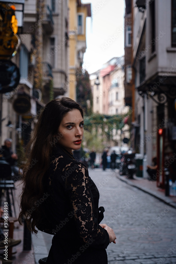 Beautiful woman walks at Istiklal street,a popular location in Istanbul