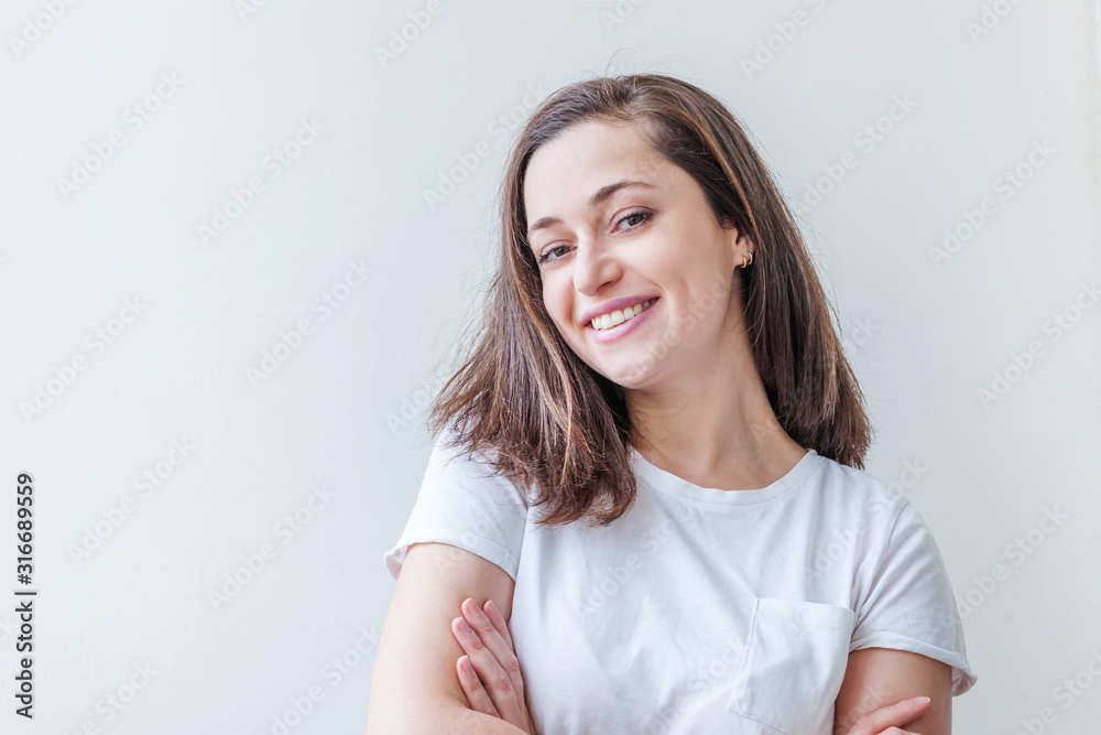 Fototapeta premium Happy girl smiling. Beauty portrait young happy positive laughing brunette woman on white background isolated. European woman. Positive human emotion facial expression body language