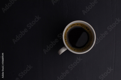 Black closeup on dark backdrop. Coffee espresso on dark background.