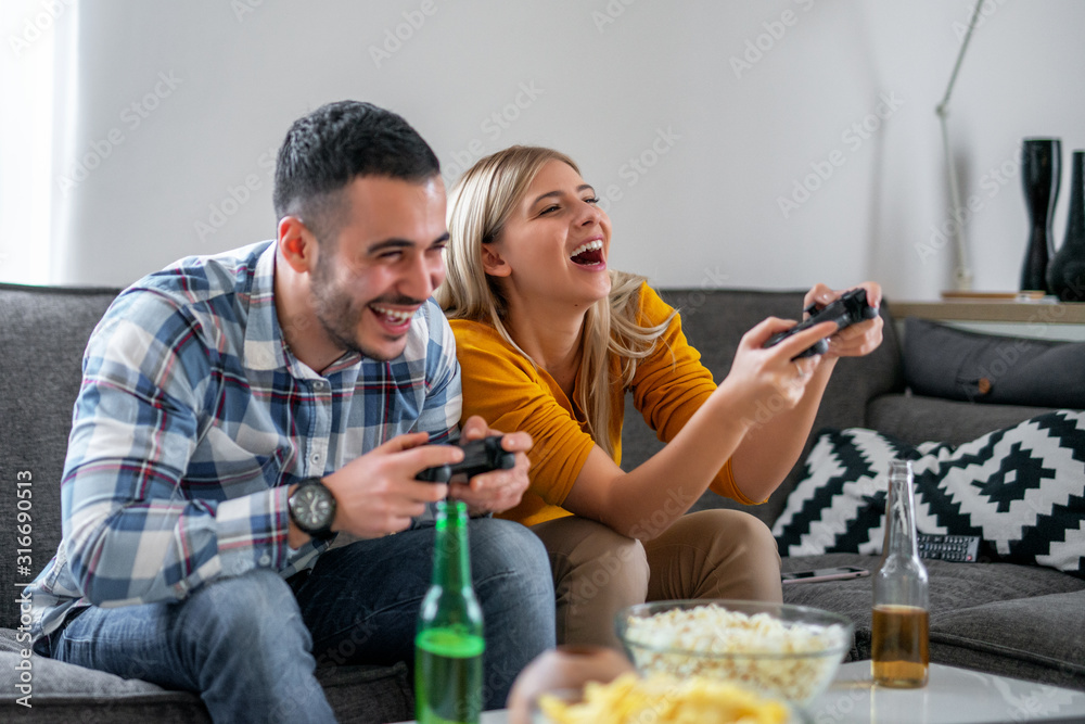Young couple playing video games at home Young couple playing video games at home