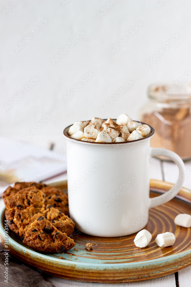 Hot chocolate with marshmallows in a white mug on a white background. Recipes. Hot chocolate with marshmallows in a white mug on a white background. Recipes.