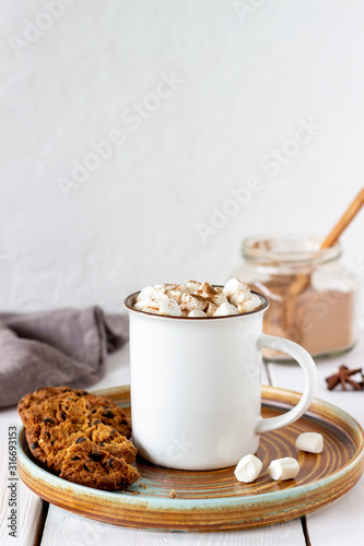 Hot chocolate with marshmallows in a white mug on a white background. Recipes.
