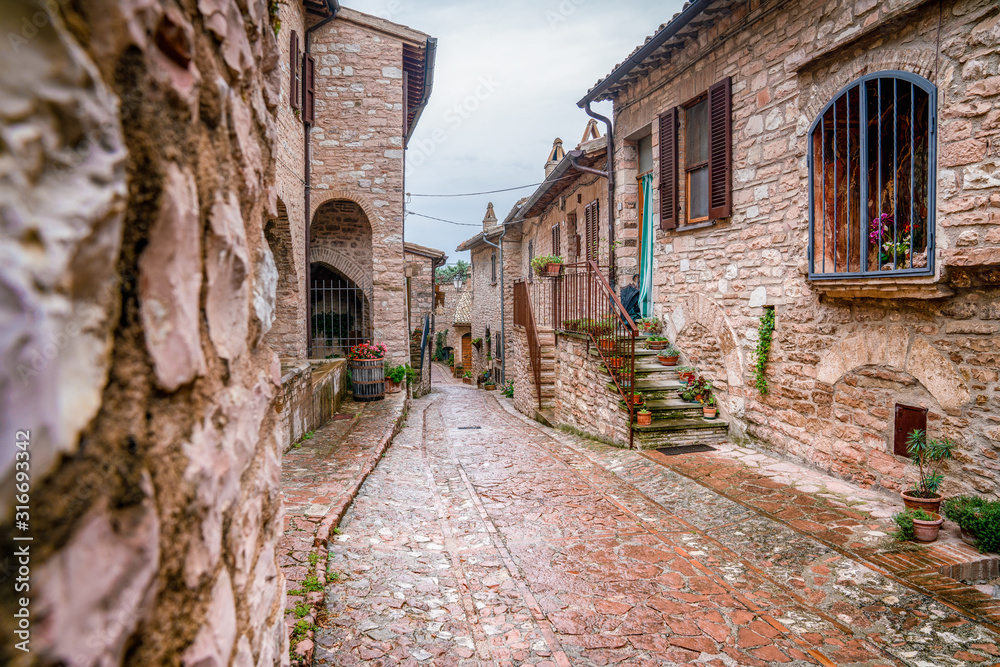 Narrow street with brick walls in a town