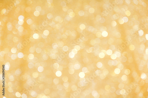 Gold yellow sparkle bokeh glitter abstract on christmas light background © Amphawan