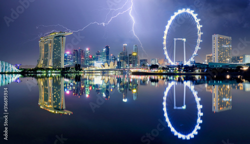 Singapore at night with storm and lightning bolt