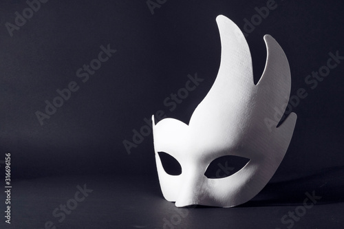 white carnival mask on a black background. concept of carnival, holiday, festival..