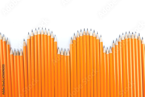 Close up view of a bunch of yellow pencils isolated on a white background. - Image