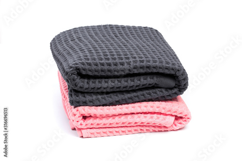 Colorful stacked bath towels isolated on white background. - Image