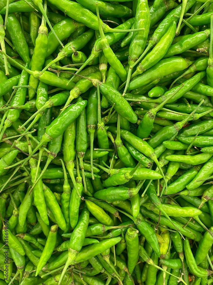 fresh ripe green hot chili close up in market. healthy food texture. vegetables background. fresh ripe green hot chili close up in market. healthy food texture. vegetables background.