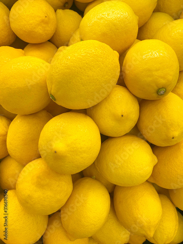 fresh lemons close up in market. healthy food texture. fruit background.