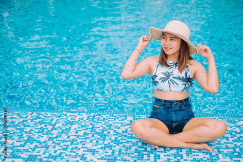 young woman in swimming pool summer concept and travel background.