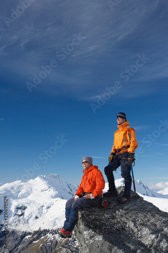 Mountain climbers on mountain peak © moodboard